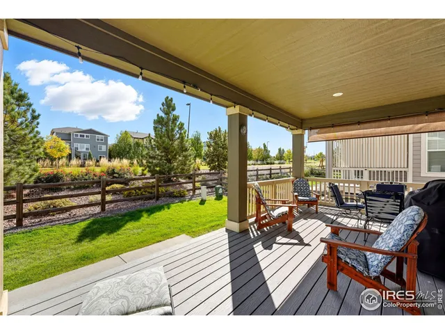 a living room with furniture gym equipment and large window