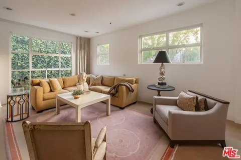 a living room with furniture and a piano