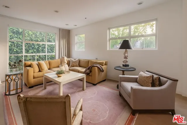 a living room with furniture and a piano