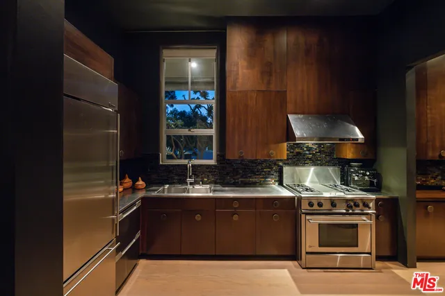 a kitchen with stainless steel appliances a stove and a refrigerator
