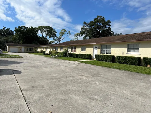 a view of house with yard and outdoor space