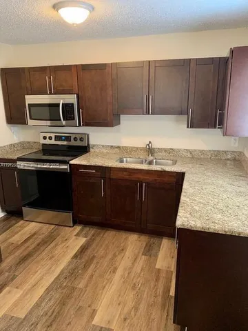 a kitchen with wooden cabinets and a sink