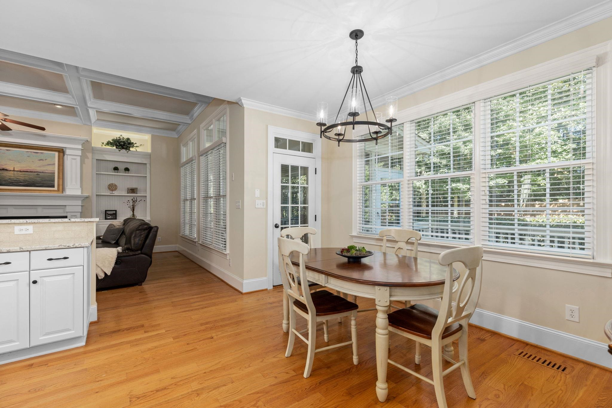 3720 Grandbridge Drive Apex, NC 27539 - Photo 23 of 81 a dining room with furniture a chandelier and wooden floor