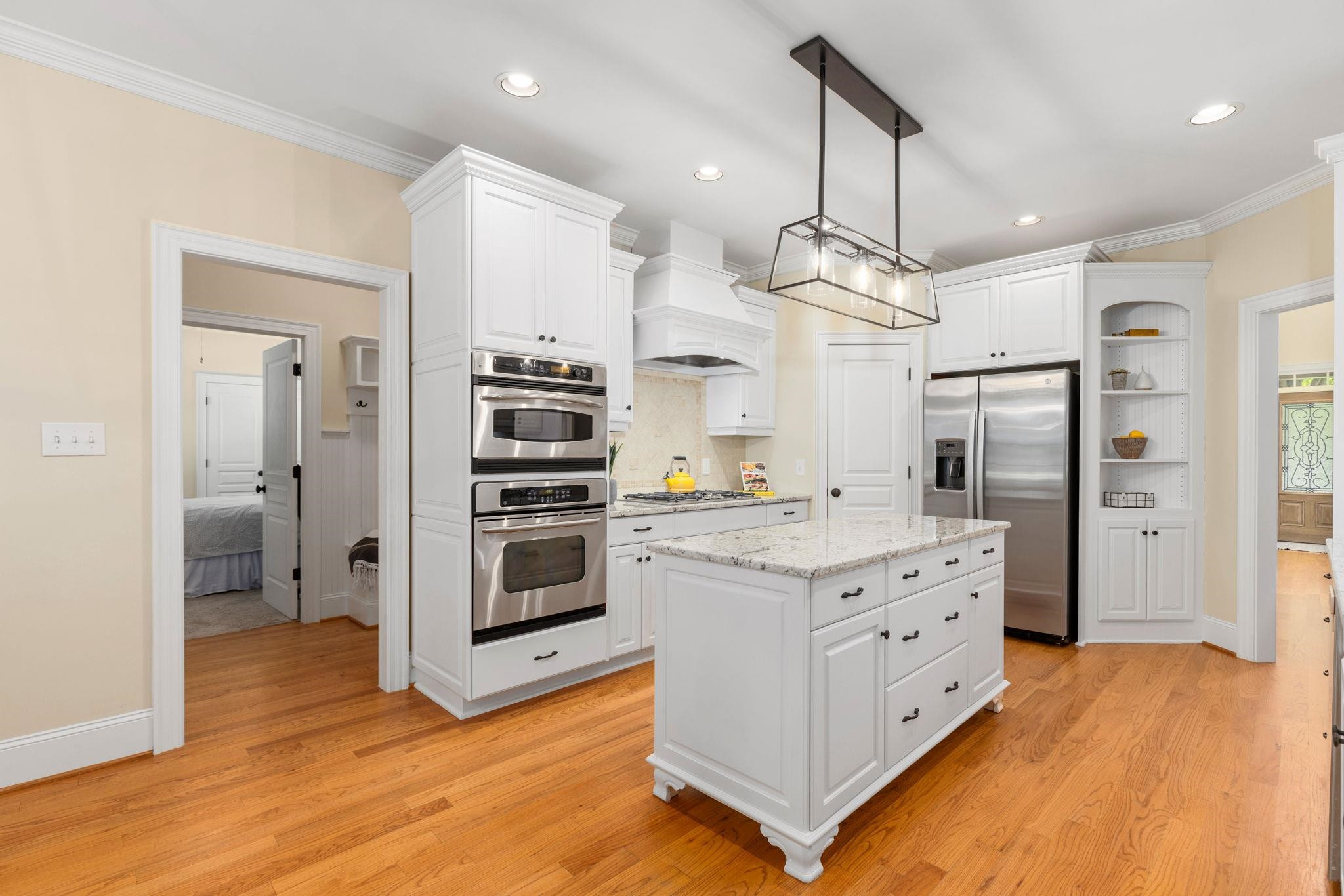 3720 Grandbridge Drive Apex, NC 27539 - Photo 28 of 81 a kitchen with stainless steel appliances kitchen island granite countertop a refrigerator and a stove top oven