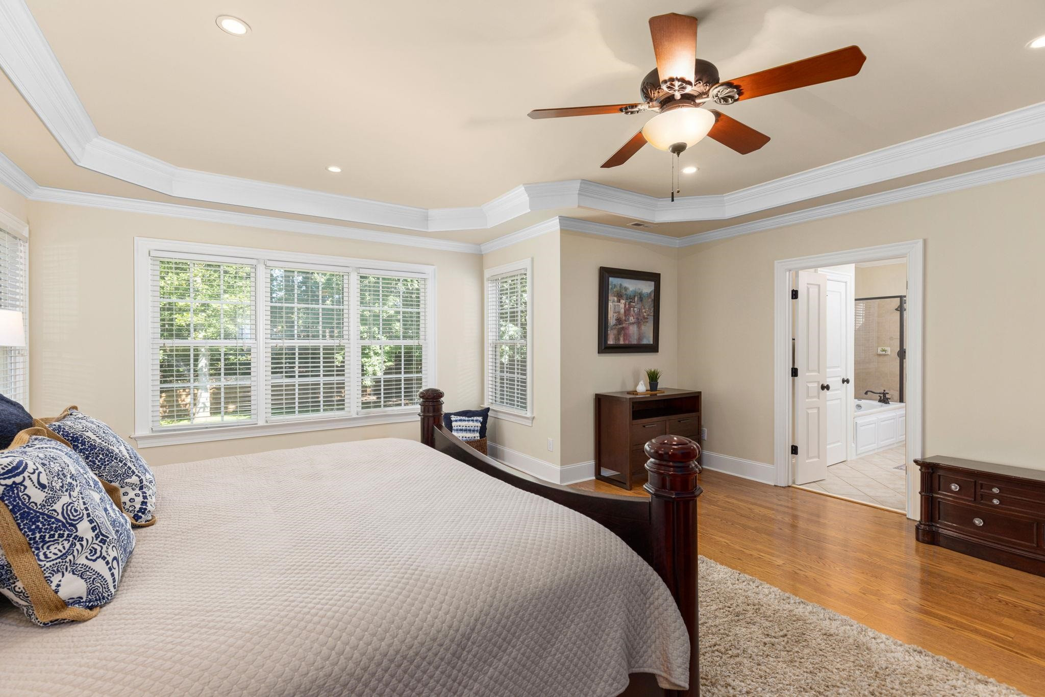 3720 Grandbridge Drive Apex, NC 27539 - Photo 43 of 81 a spacious bedroom with a large bed and a chandelier