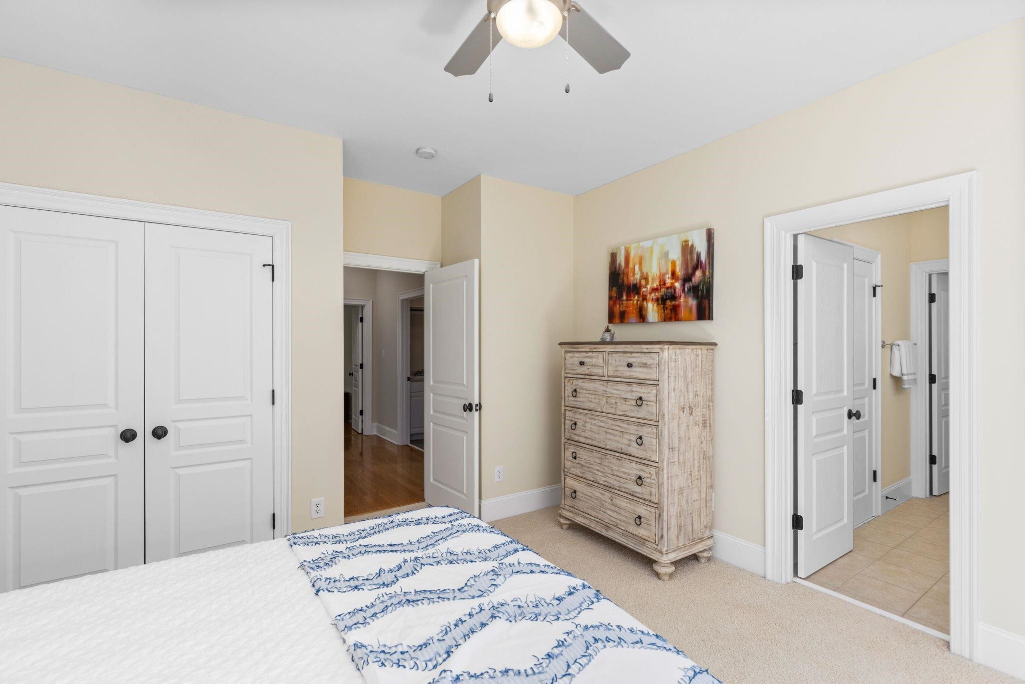 3720 Grandbridge Drive Apex, NC 27539 - Photo 51 of 81 a bedroom with a bed and a chandelier