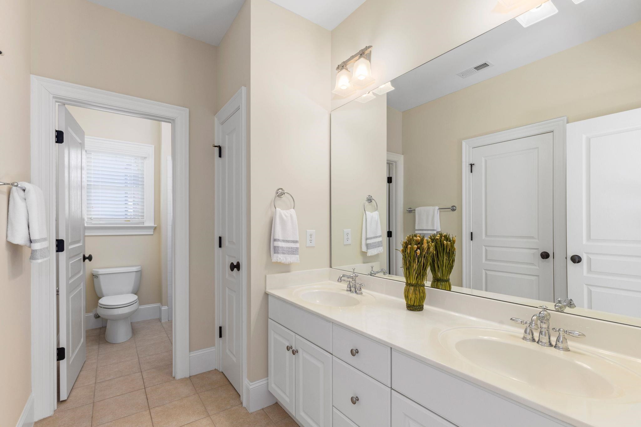 3720 Grandbridge Drive Apex, NC 27539 - Photo 52 of 81 a bathroom with a double vanity sink toilet and shower