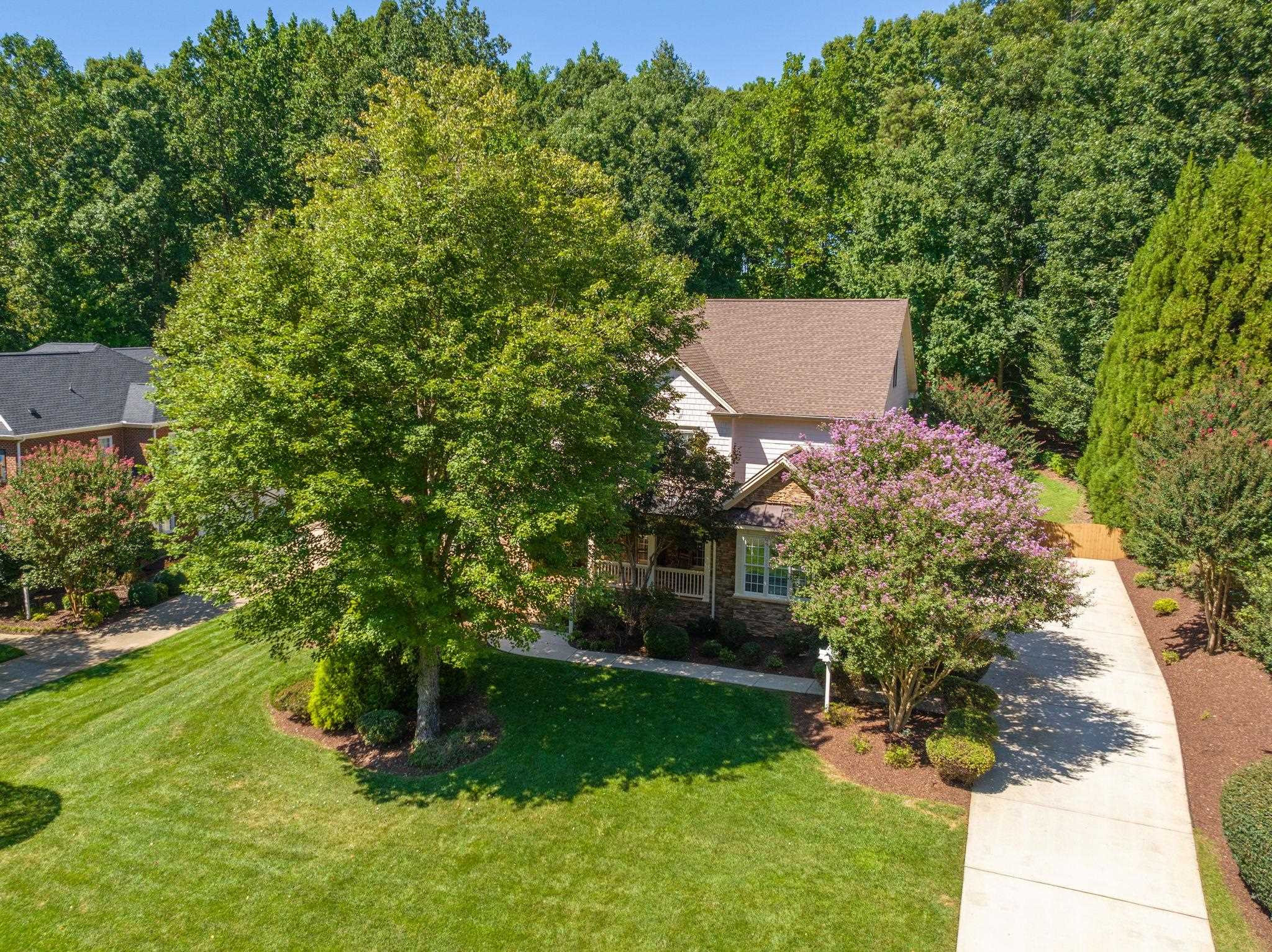 3720 Grandbridge Drive Apex, NC 27539 - Photo 72 of 81 a view of a backyard with plants and a garden