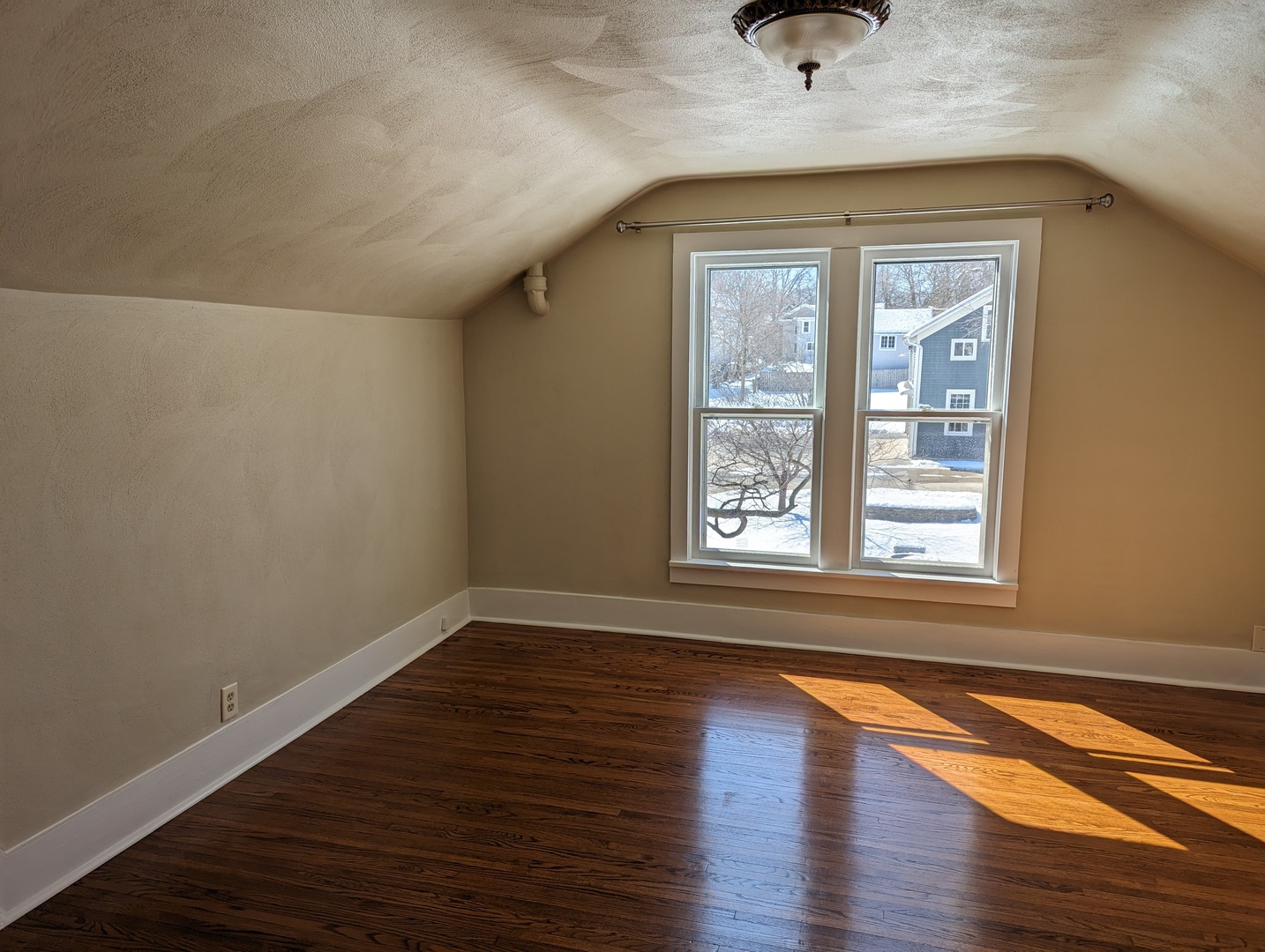 837 West Stephenson Street, Unit UP Freeport, IL 61032 - Photo 14 of 17 a view of an empty room with wooden floor and a window
