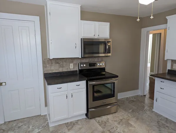 a kitchen with a refrigerator and a table