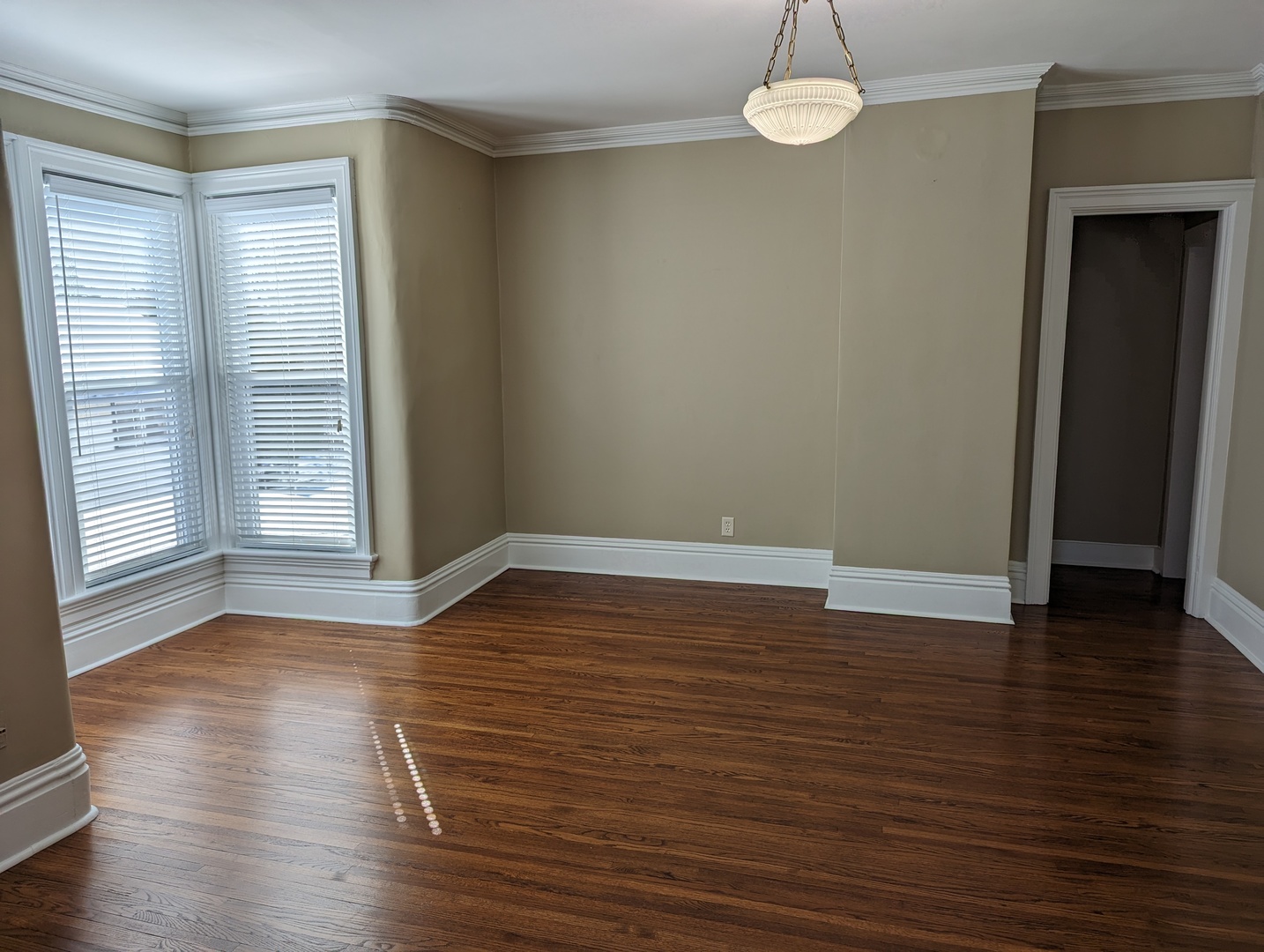 837 West Stephenson Street, Unit UP Freeport, IL 61032 - Photo 8 of 17 an empty room with wooden floor and windows