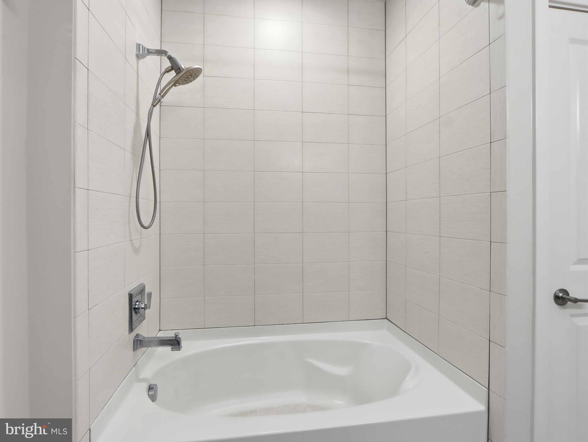 8005 13th Street, Unit 411 Silver Spring, MD 20910 - Photo 31 of 33 a bathroom with a bath tub with a shower