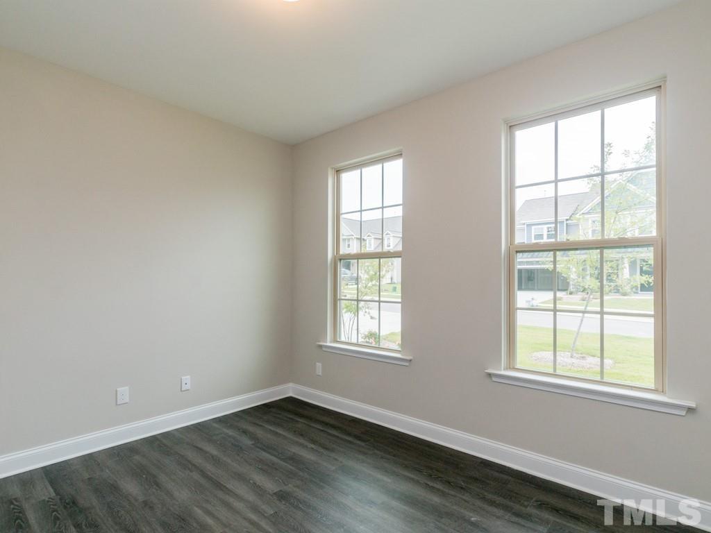 131 Weldon Lane Angier, NC 27501 - Photo 11 of 24 an empty room with wooden floor and windows