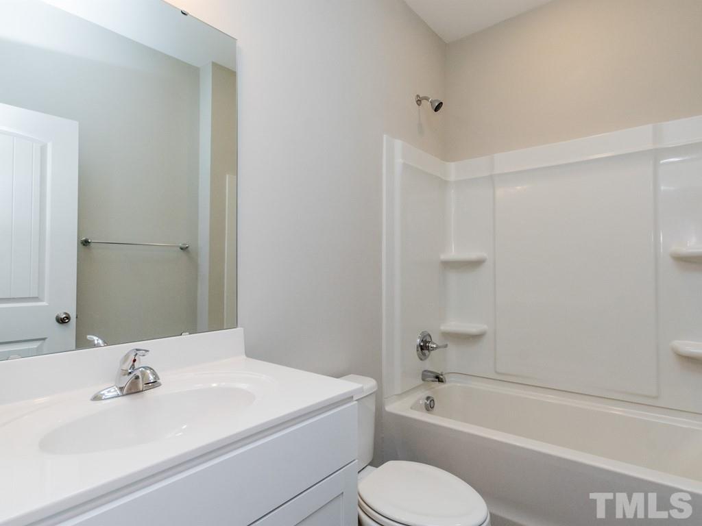131 Weldon Lane Angier, NC 27501 - Photo 12 of 24 a bathroom with a toilet a sink and a bathtub