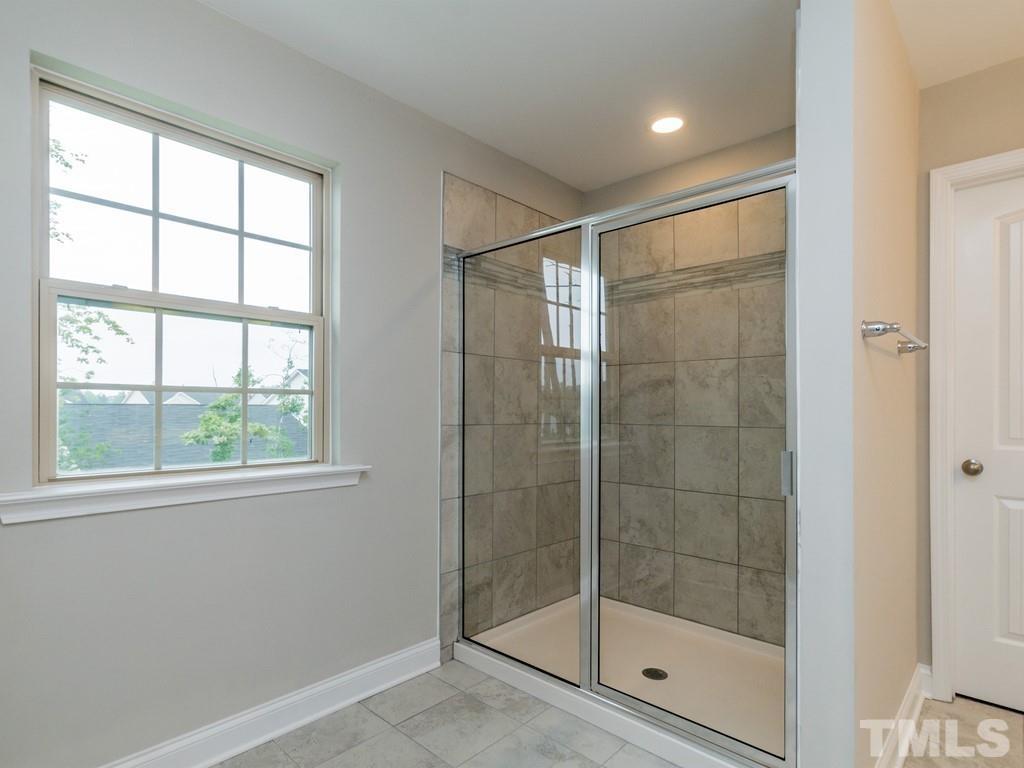 131 Weldon Lane Angier, NC 27501 - Photo 18 of 24 a bathroom with a glass shower door