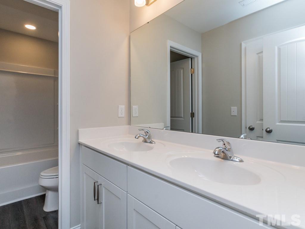 131 Weldon Lane Angier, NC 27501 - Photo 20 of 24 a bathroom with a sink and a mirror