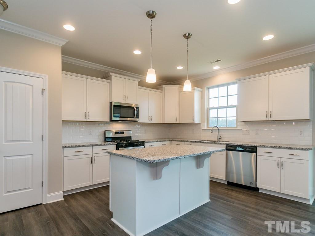 131 Weldon Lane Angier, NC 27501 - Photo 9 of 24 a kitchen with stainless steel appliances granite countertop a sink a stove a refrigerator and white cabinets