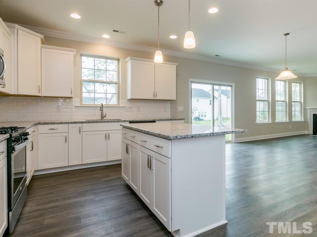 131 Weldon Lane Angier, NC 27501 - Photo 10 of 24 a kitchen with granite countertop white cabinets and white appliances