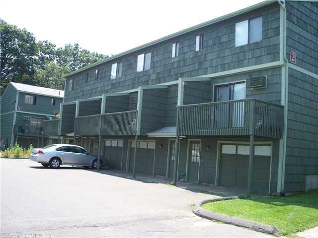 1400 Meriden Road, Unit 43 Waterbury, CT 06705 - Photo 1 of 1 a view of a brick house with a yard and large parking space
