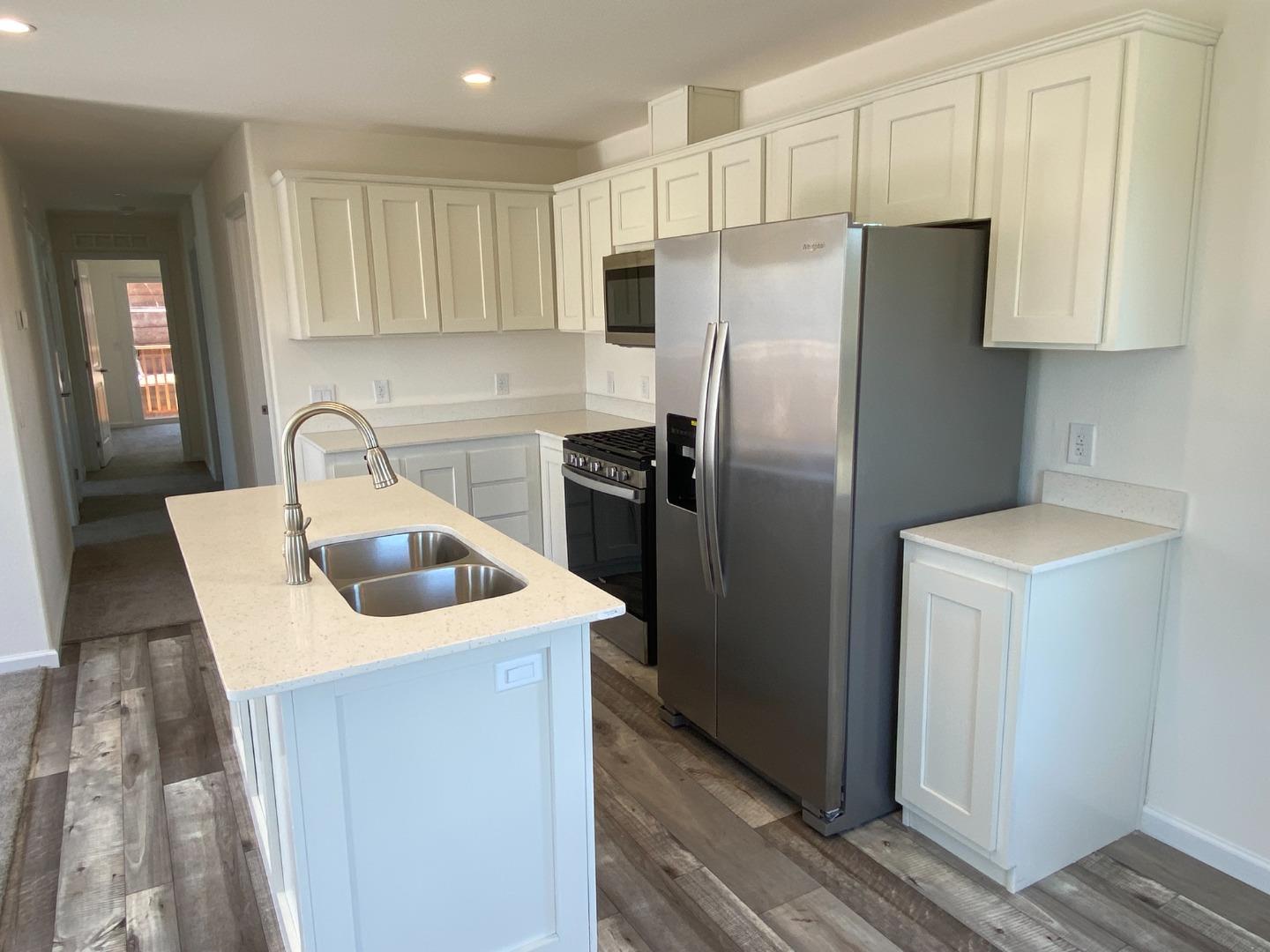 128 Pera Drive, Unit 128 Watsonville, CA 95076 - Photo 16 of 29 a kitchen with stainless steel appliances granite countertop a refrigerator a sink and a stove