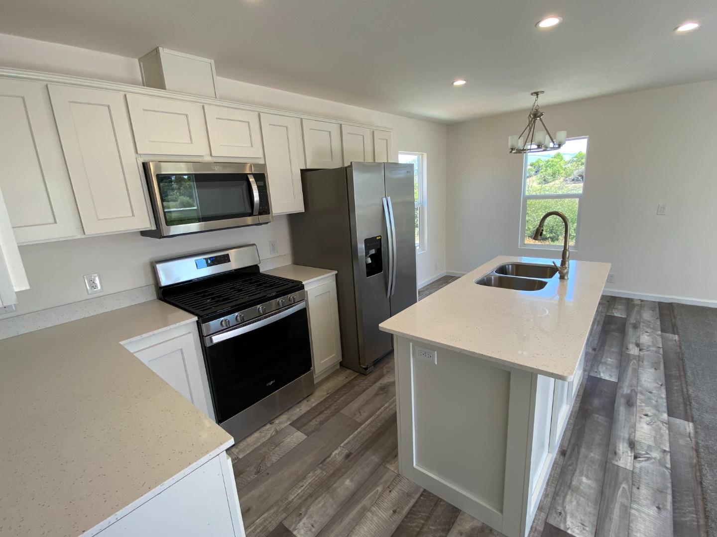128 Pera Drive, Unit 128 Watsonville, CA 95076 - Photo 17 of 29 a kitchen with stainless steel appliances a stove microwave and refrigerator