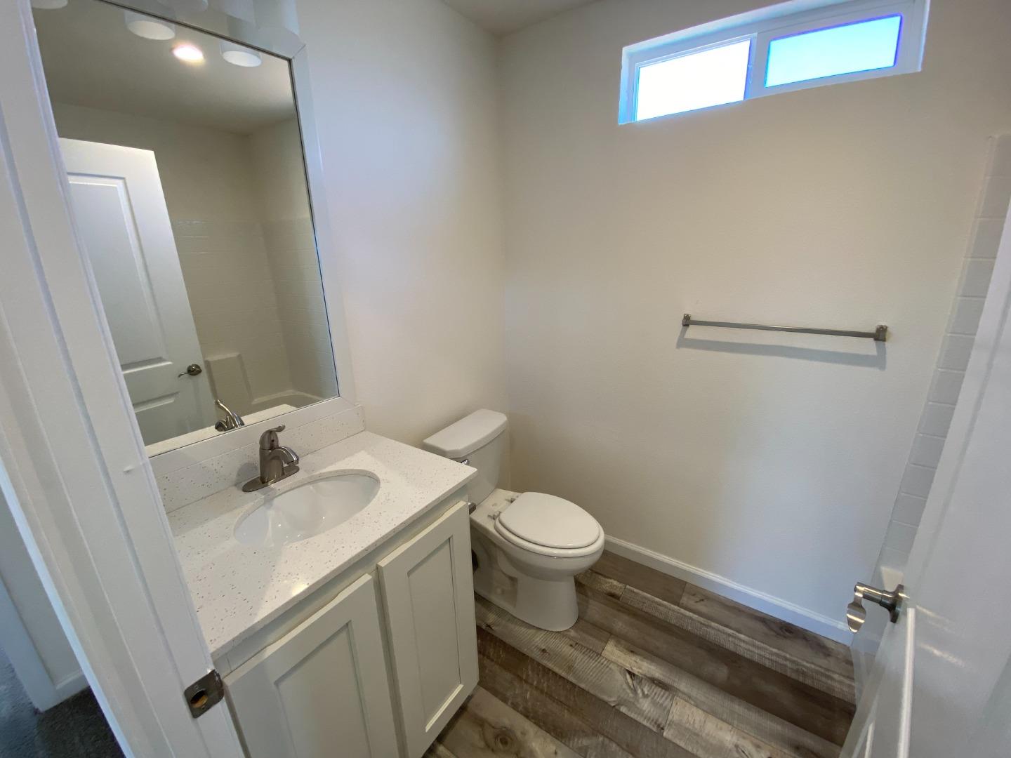 128 Pera Drive, Unit 128 Watsonville, CA 95076 - Photo 26 of 29 a bathroom with a sink toilet and vanity