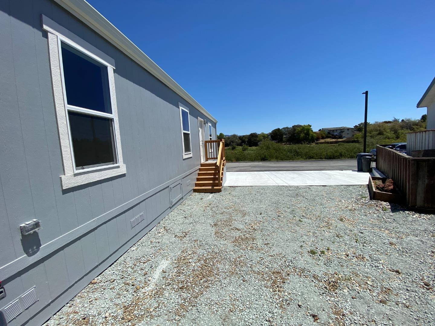 128 Pera Drive, Unit 128 Watsonville, CA 95076 - Photo 7 of 29 a backyard of a house with lake view and a floor to ceiling window
