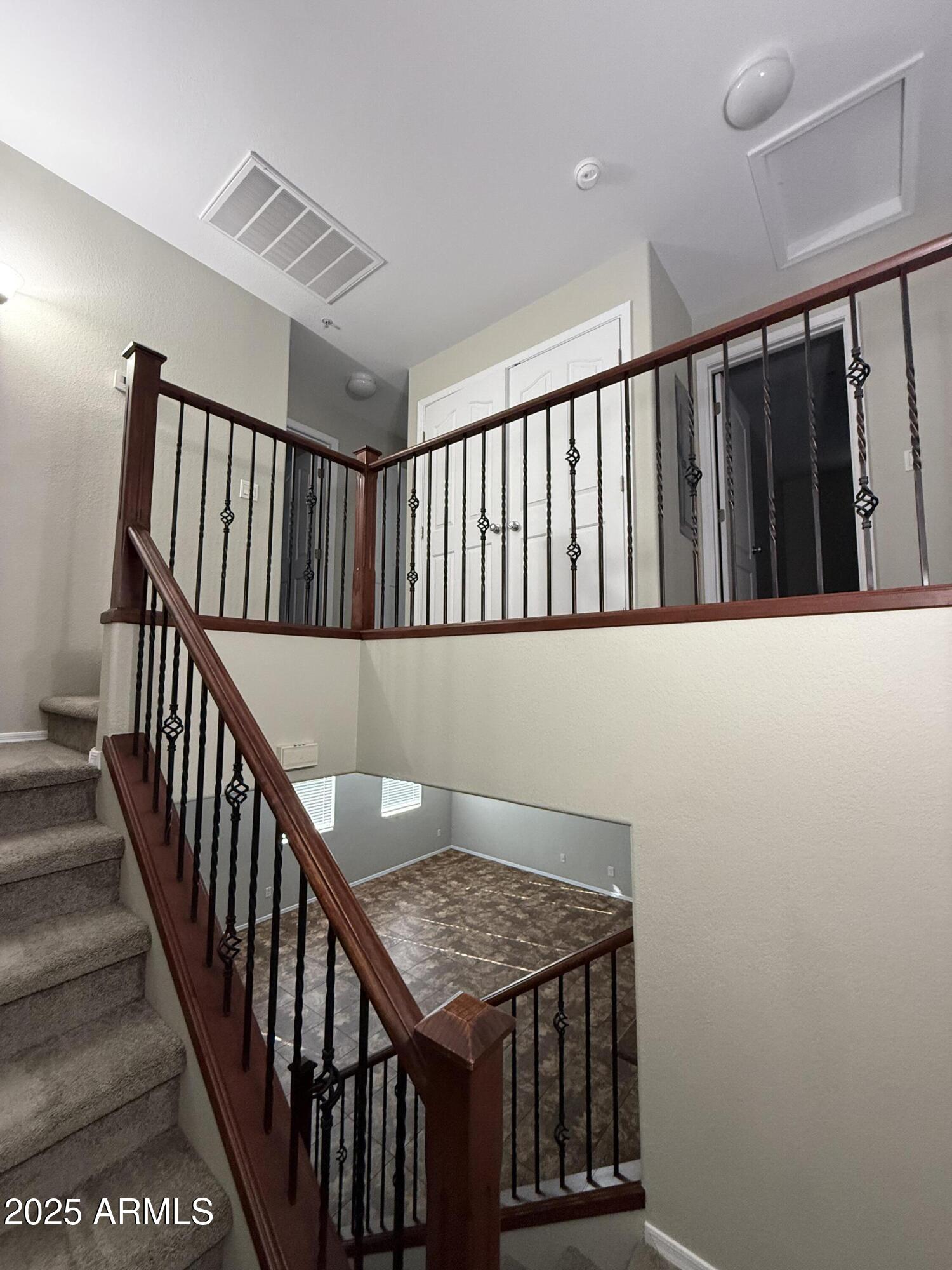 1265 South Aaron, Unit 351 Mesa, AZ 85209 - Photo 13 of 17 a view of staircase with railing and white walls