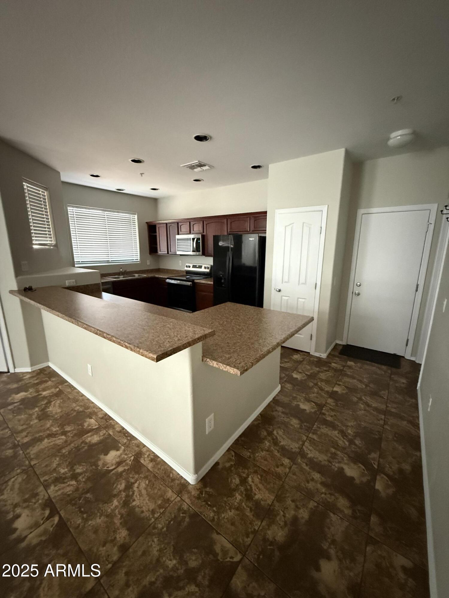 1265 South Aaron, Unit 351 Mesa, AZ 85209 - Photo 14 of 17 a large kitchen with cabinets appliances and a counter space