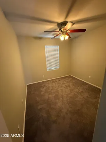 a view of room with window and ceiling fan