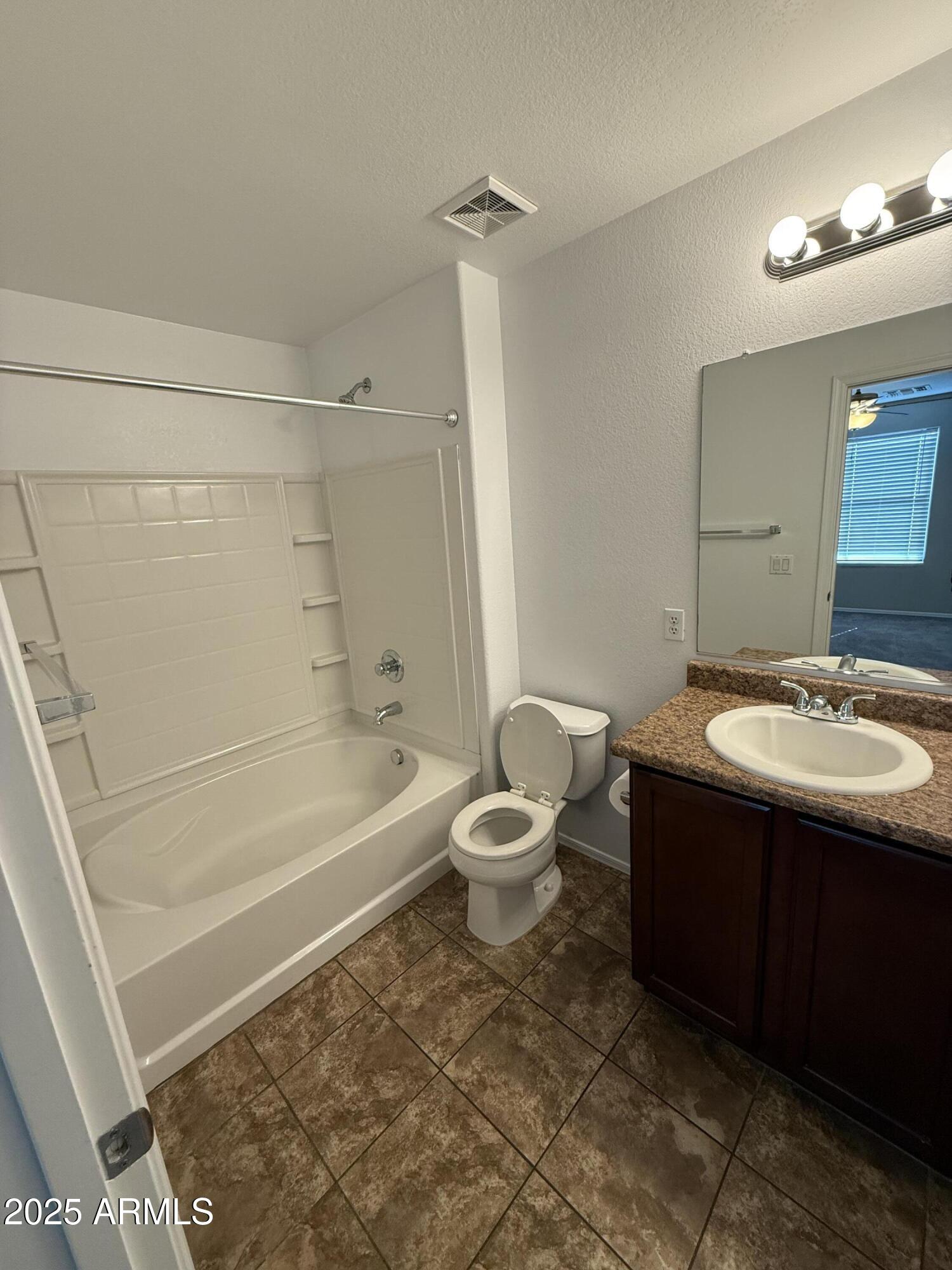 1265 South Aaron, Unit 351 Mesa, AZ 85209 - Photo 10 of 17 a bathroom with a sink a toilet and shower