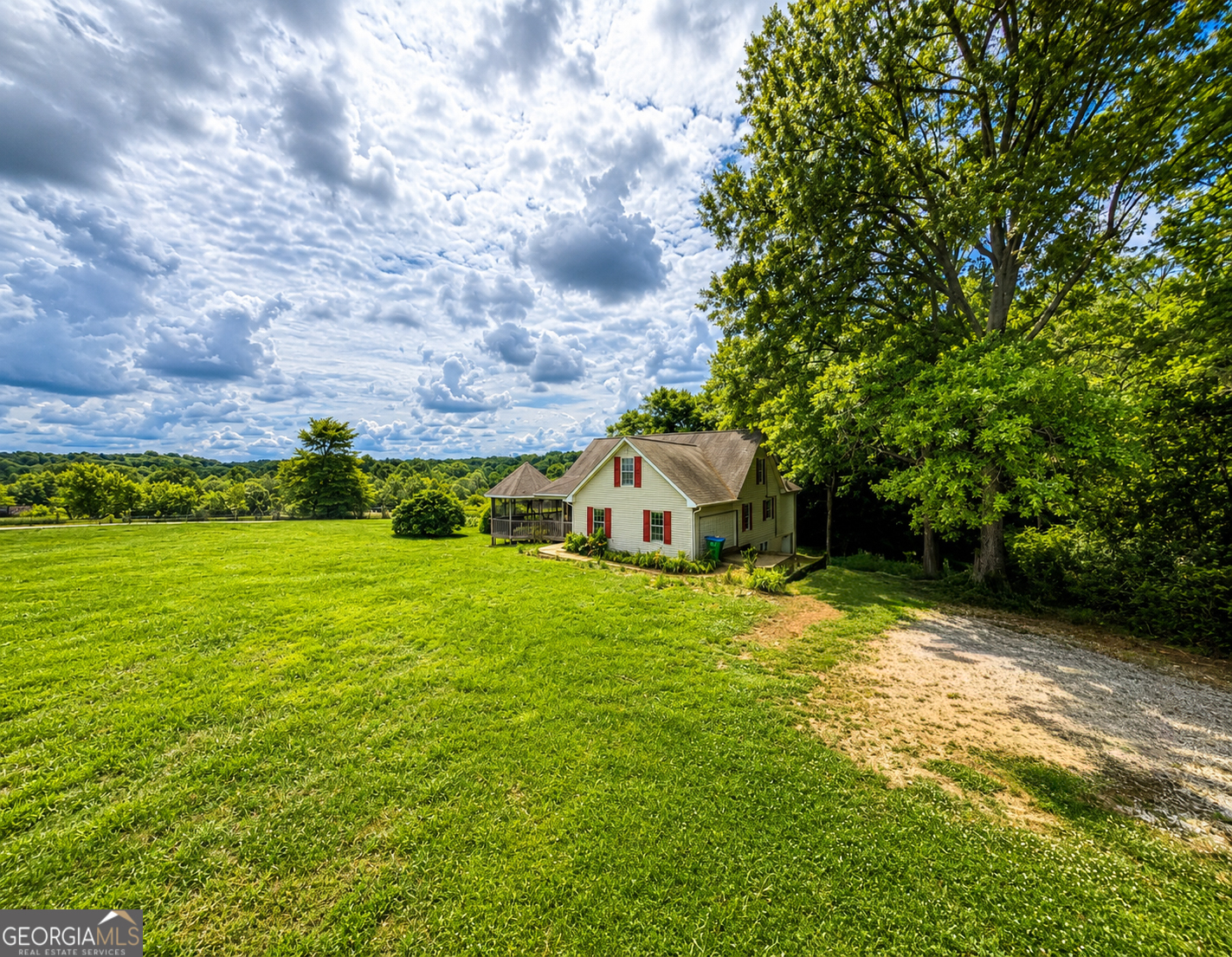 2433 Bear Creek Road Statham, GA 30666 - Photo 11 of 58 a view of a big yard with plants and large trees