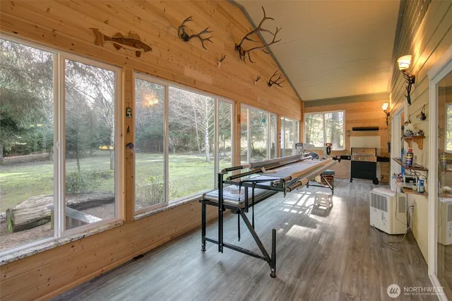 a living room with furniture a wooden floor and next to a window
