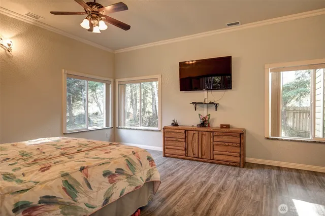 a bedroom with a bed and a flat screen tv