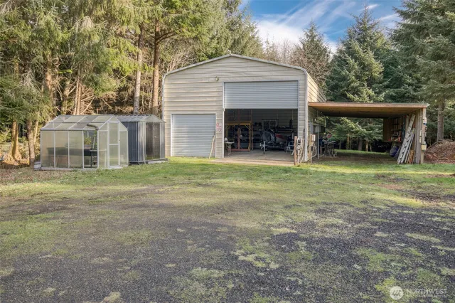 a view of a house with a yard and a garage
