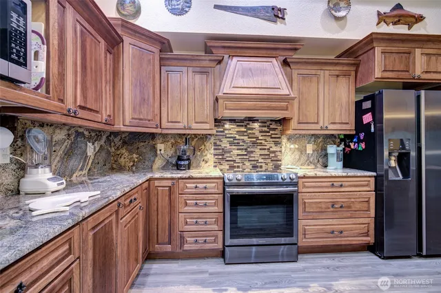 a kitchen with stainless steel appliances granite countertop a sink and cabinets