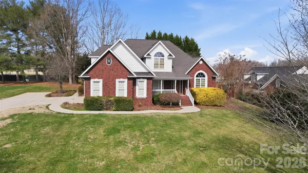a view of a livingroom with wooden floor and a chandelier