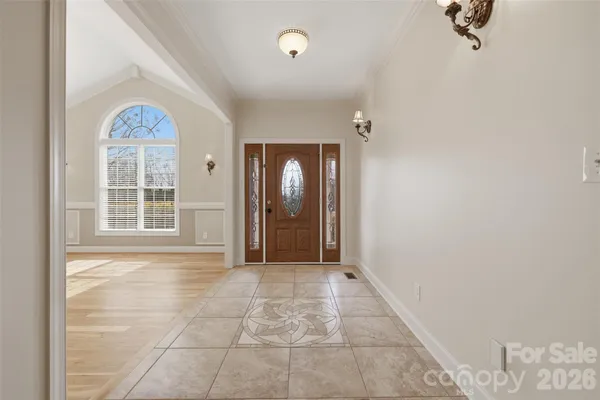 a view of an empty room with a fireplace and a window