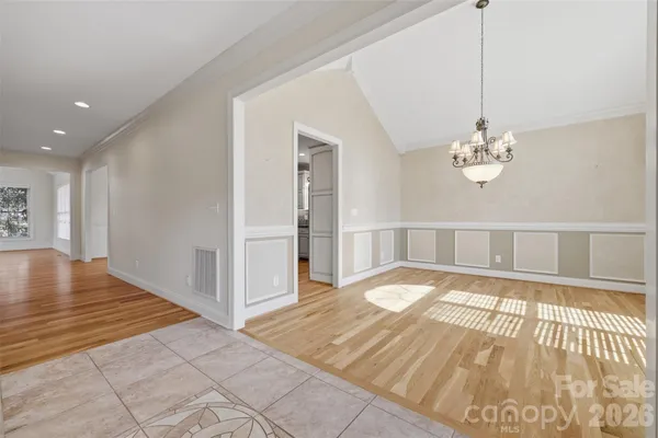 a view of an empty room with a fireplace and a window