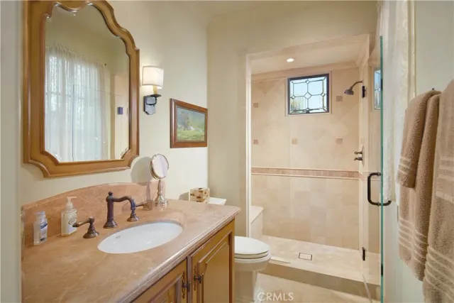 a bedroom with a bed a dresser and chair