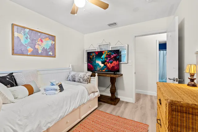 a bedroom with furniture and a flat screen tv