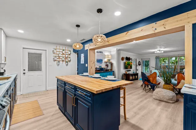 a large kitchen with stainless steel appliances granite countertop a large stove a sink and a refrigerator