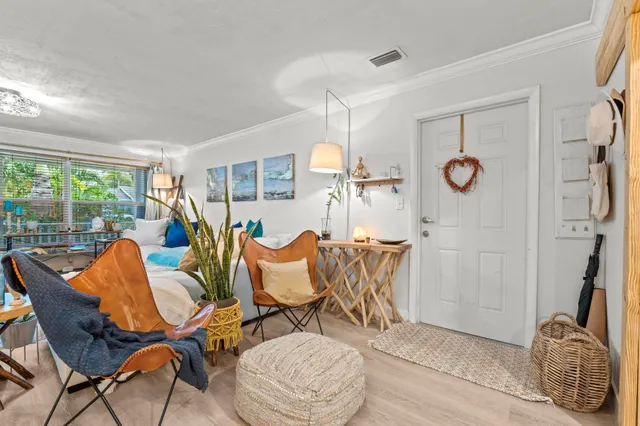a living room filled with furniture and a floor to ceiling window