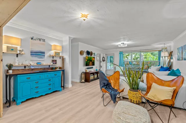 a living room with furniture a fireplace and large windows