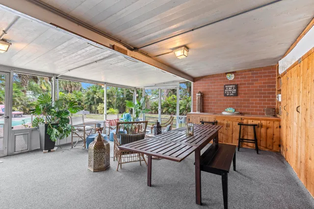 a view of a patio with a table and chairs