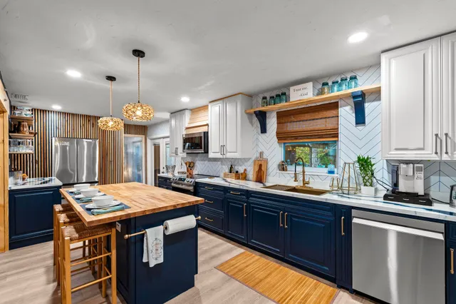 a kitchen with a stove a sink and a refrigerator