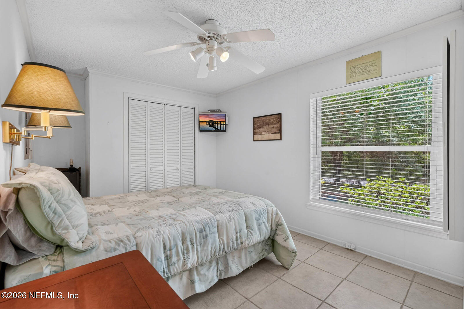 1950 Lightsey Road St. Augustine, FL 32084 - Photo 19 of 57 a bedroom with a bed and a painting on the wall