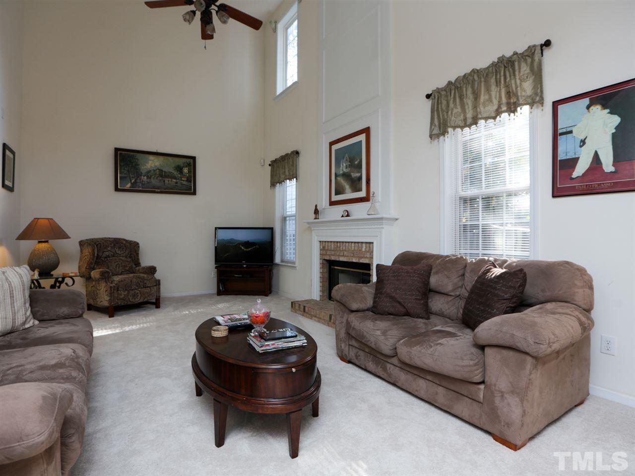 4604 Drewbridge Way Raleigh, NC 27604 - Photo 11 of 24 a living room with furniture and a fireplace
