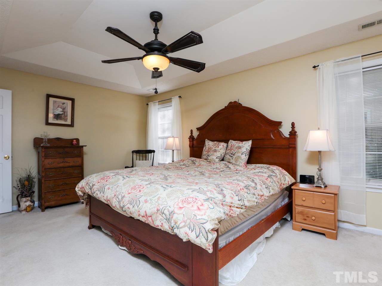 4604 Drewbridge Way Raleigh, NC 27604 - Photo 13 of 24 a bedroom with a bed and dresser