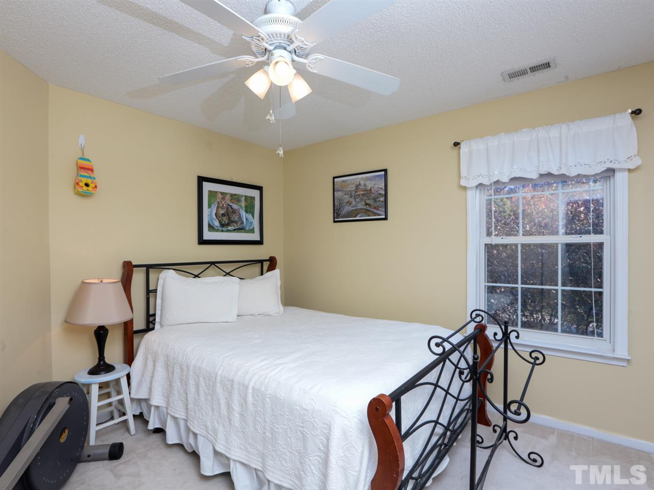 4604 Drewbridge Way Raleigh, NC 27604 - Photo 17 of 24 a bedroom with a bed and a window